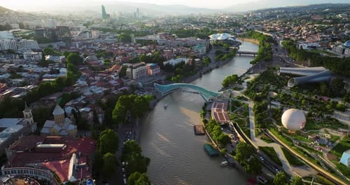 Tbilisi, Capital City Of The Republic Of Georgia, On The Mtkvari River At Sunset. Aerial Shot