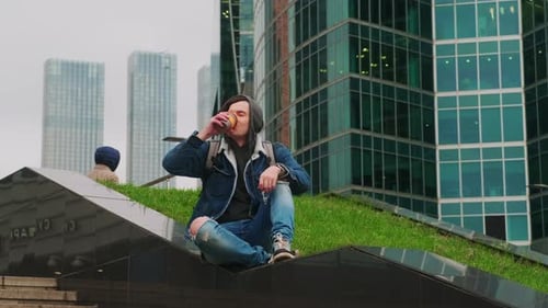 Young Adult Drinking Beverage in Urban Setting