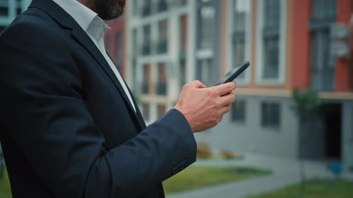 Bearded Adult Using Mobile Phone in Urban Setting