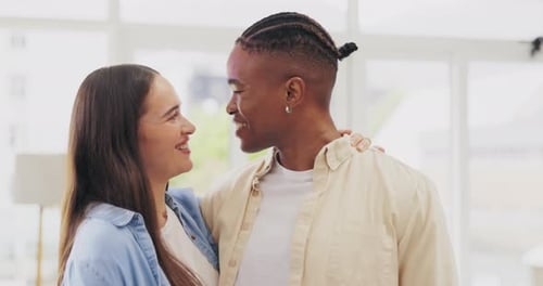 Happy Young Couple Smiling and Embracing Indoors