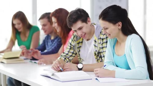 Education, Friendship And School Concept - Five Smiling Students Writing In Textbooks And Reading...