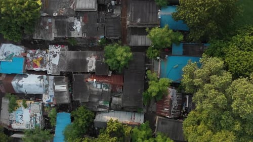 Ascending top view of poor suburbs with old destroyed housing area.Rooftop pattern texture.Third Wor