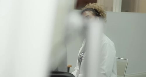 Female Doctor Examining Patient in Doctors Office