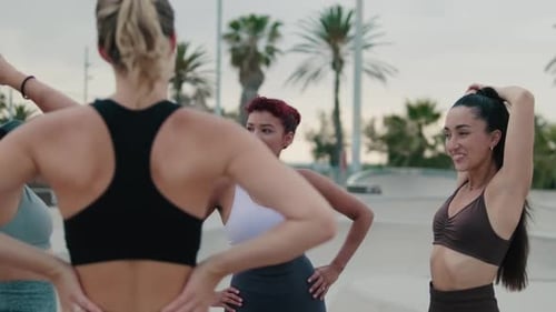 Young Women Exercising Together in Urban Park