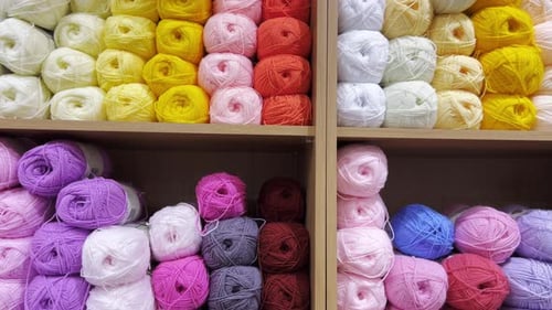 Many Colorful Balls of Wool Yarn in a Fabric Store Background From Colored Cotton Yarn