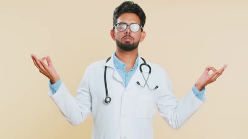 Relaxed Doctor Meditating to Reduce Stress