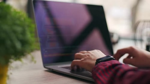Close Up of Freelancer's Hands Typing Code on Laptop Keyboard Camera Slides Around Developer's