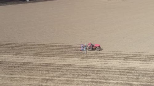 Aerial View Tractor on the Field Cultivates the Soil