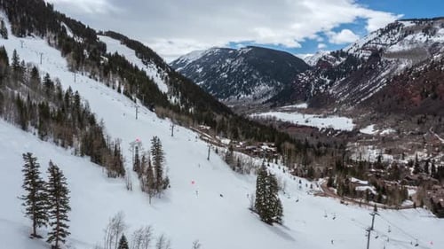Ski Resort - Skiers Skiing Down The Snowy Mountains. - aerial hyperlapse shot