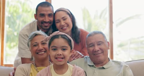 Smiling Multi-Generational Family Portrait on Sofa
