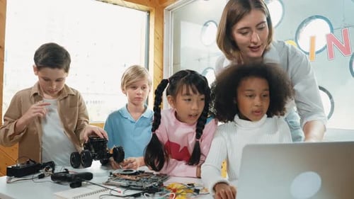 Children Learning Coding with Teacher in Classroom
