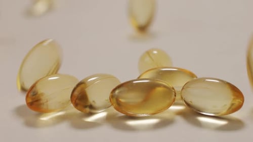 Omega Fish Oil Pills Dietary Supplement Falling Down on White Background Omega Fish Oil Softgels