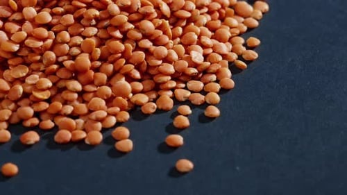 Pile of Red Lentils on Dark Background