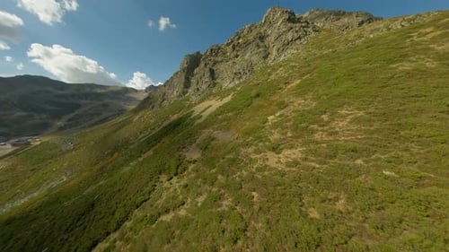 Stunning mountain landscape with grassy slopes and rocky peaks in summer