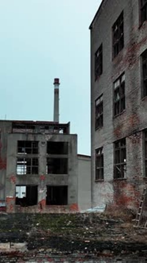 Industrial zone premises being ruined with time. Old buildings with broken windows
