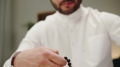 Middle Eastern Man Praying with Rosary Reading Quran Closeup Islamic Religion