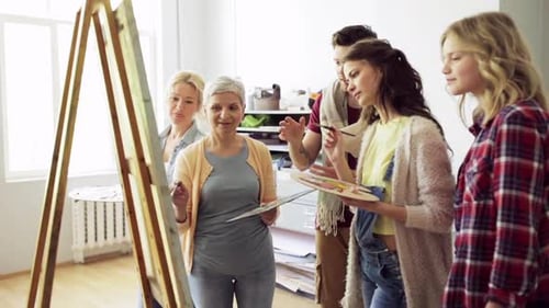 Group of people in art class painting canvas