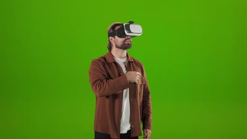 Man in VR Headset Over Green Background