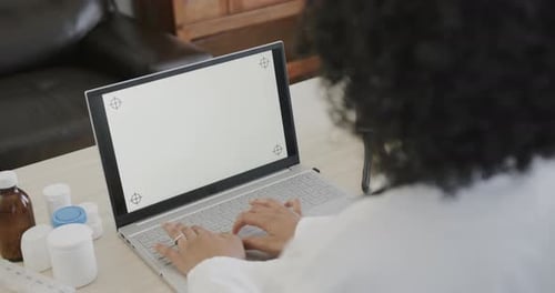 Doctor Typing on Laptop with Blank Screen