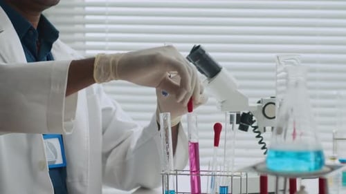 Scientist Conducts Experiment in Brightly Lit Lab