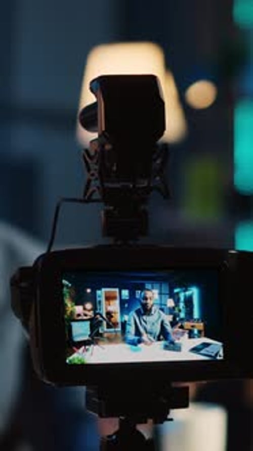 Broadcasting Live with Camera, Man at Desk
