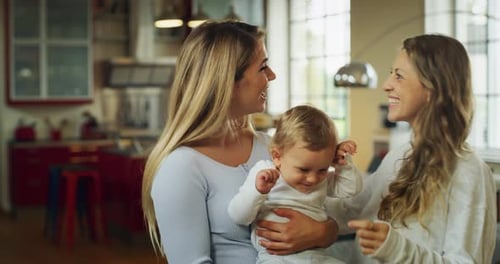 Two Women and Baby Smile at Camera