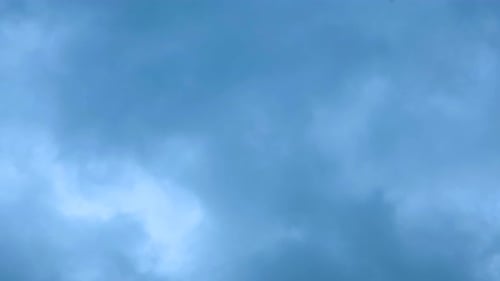 Clouds Drifting Across Blue Sky From Above