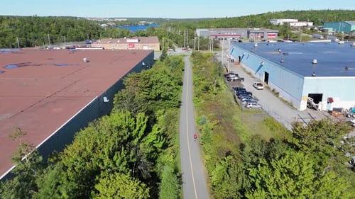 Professional Woman Cycling In Park On Summer Day In Nova Scotia View From Drone