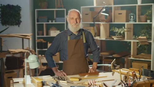Senior Man in Workshop Standing Behind Workbench
