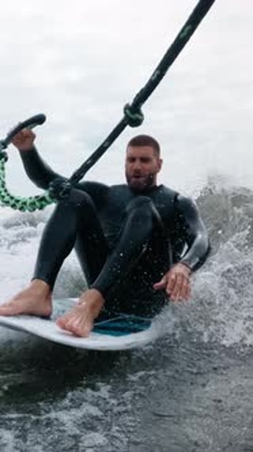 Man wakesurfing on board in ocean waves