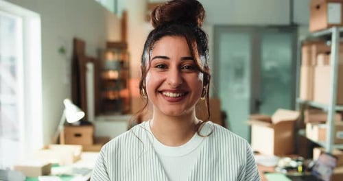 Smiling Young Woman Portrait in Bright Workplace Environment