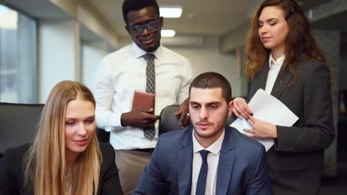 Diverse Office Corporate Workers Discuss Project on Laptop Display in Office Multiethnic People