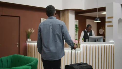 Well-Dressed Man Checking Into a Modern Hotel
