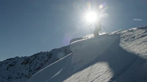 Professional Skier Performing Extreme Tricks on Snowy Mountain Peaks