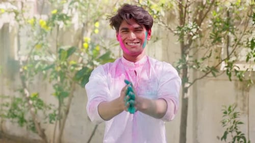 Cheerful Young Man Covered in Holi Powder
