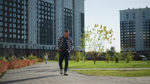 Man Walking on Path in City Park
