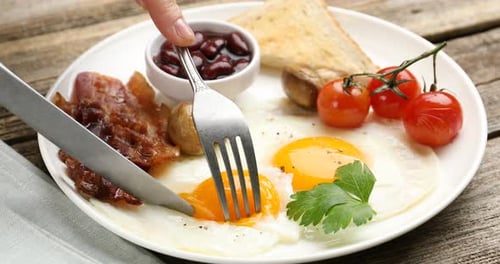 Breakfast Plate: Eggs, Bacon, Beans, Toast on Table