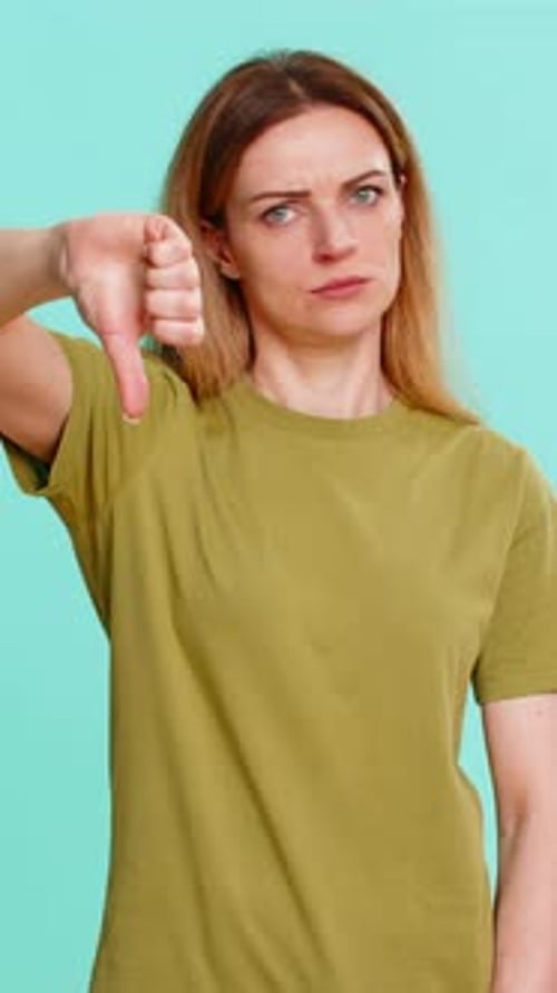 Woman expressing disapproval with thumbs down gesture