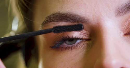 Close-up of Woman Getting Mascara Applied to Eyelashes
