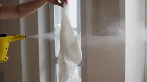 Steam Cleaner Vaporizes Water at White Cloth