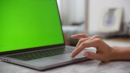 Hand Touching Trackpad of Laptop with Green Screen for Chroma Key