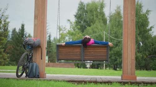 Serene Outdoor Pause Peaceful Scene with Woman and Bicycle Resting Tranquil Park Environment Showing
