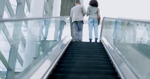 Back, airport or travel and business people on an escalator with luggage for an international trip
