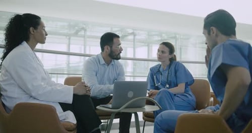 Medical Professionals Meet in Hospital Lobby to Discuss
