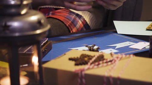 Woman Crafts Christmas Presents at Home