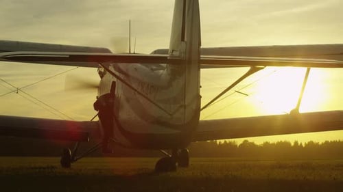 Vintage Airplane on Airfield at Sunset