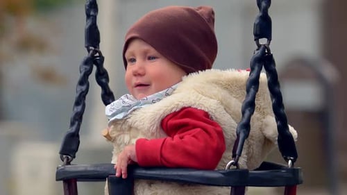 playground, chilhood - beautiful baby on the swing at the park