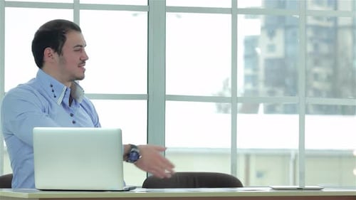 Confident Businessmen Shaking Hands in a Modern Office