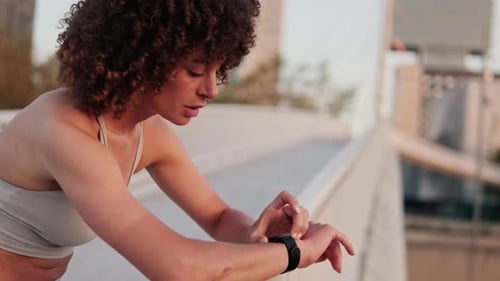 Woman Using Smartwatch After Workout Outside