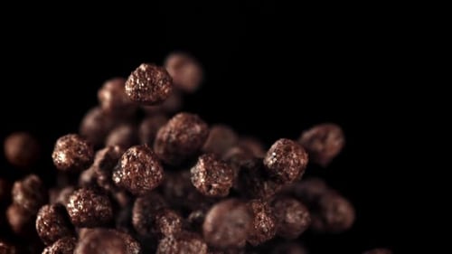 Chocolate Balls Cereal Floating on a Black Background